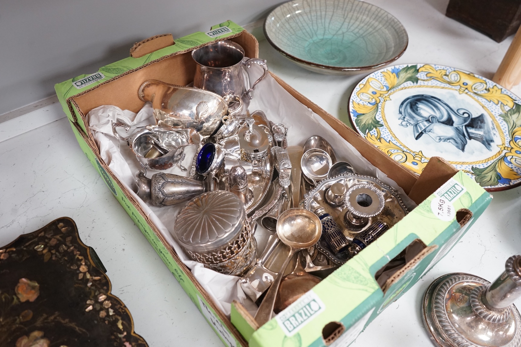 A collection of small plated wares including a pair of candle sticks, cruets, cutlery, sugar shaker, etc